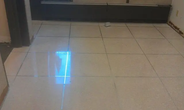 Polished vinyl composition tile floor with a clear reflection of the ceiling lights